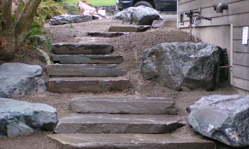 View more about Large Stone Slab Staircase with Landscaping Boulders